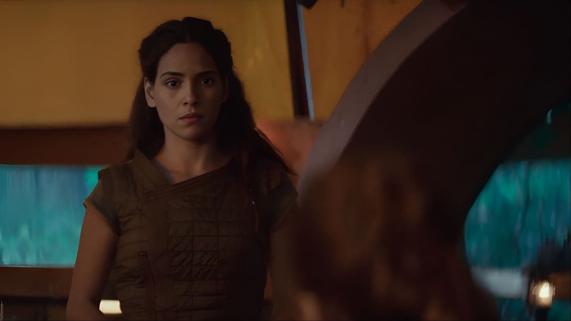 Bix prepares to confront the visitor at her doorstep, her expression betraying uncertainty about the path ahead. (Image via Disney+)